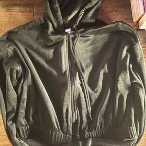 Black soft velvet crop zip up jacket has love written on one sleeve.